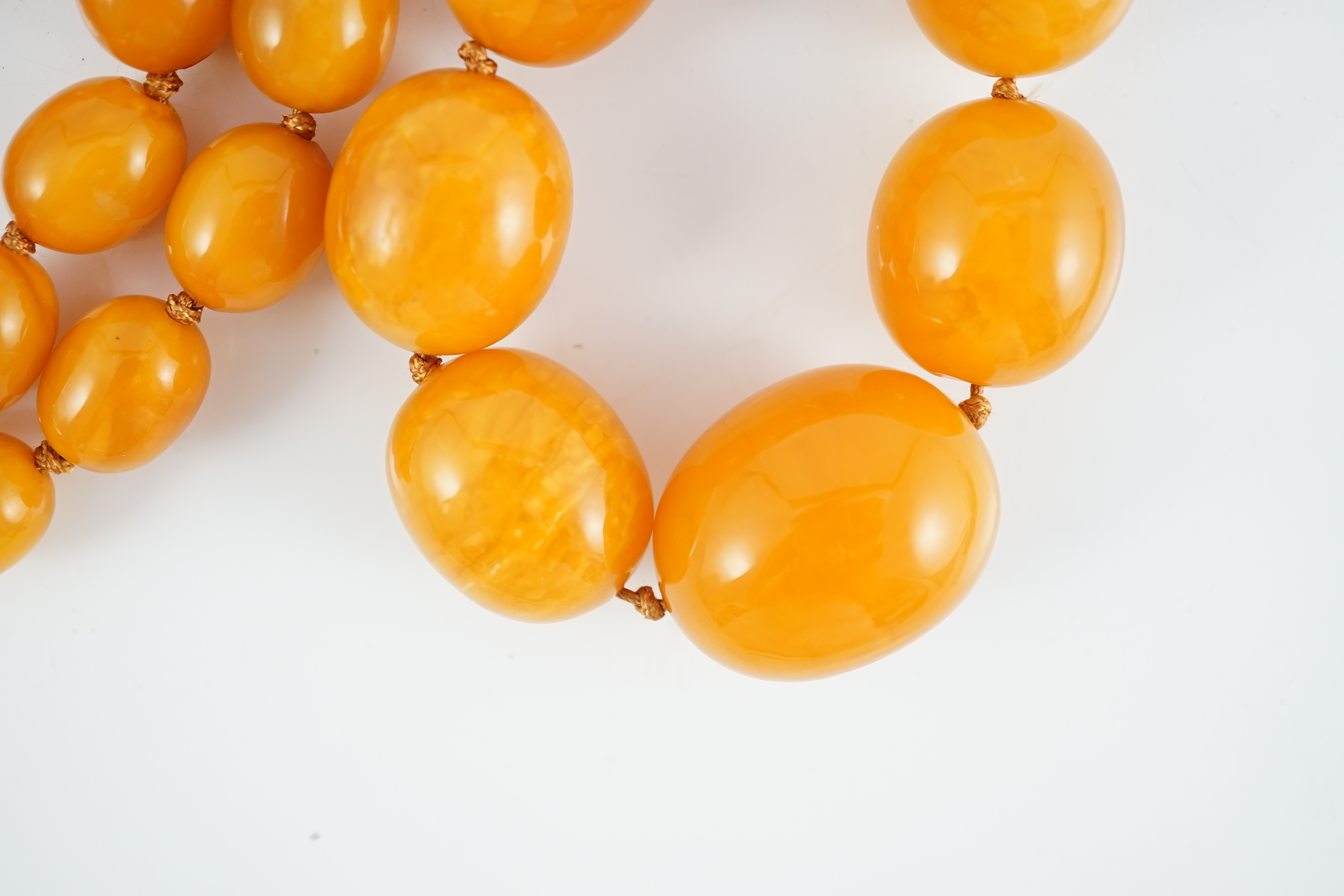 A single strand graduated oval amber bead necklace, 110cm, gross weight 163 grams